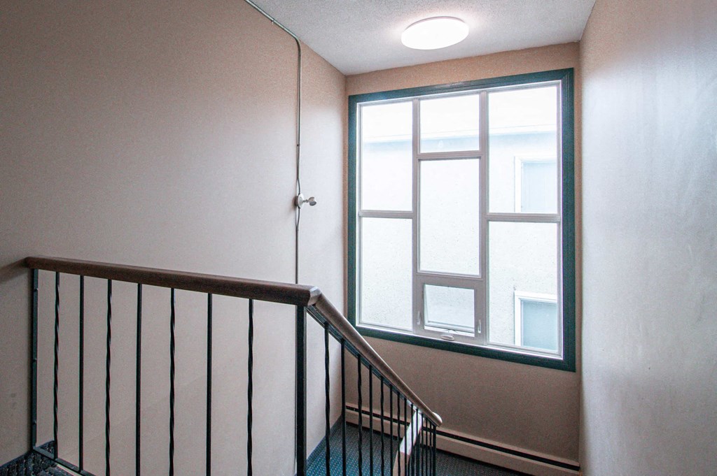 a stairwell with a window and a staircase