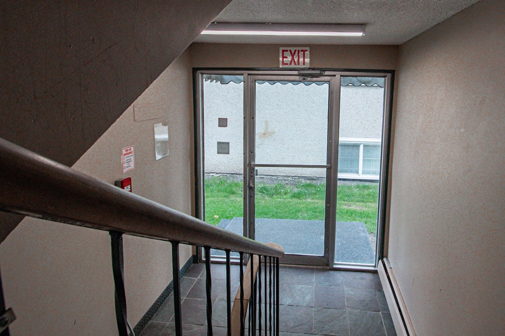 an exit sign above a door in a stairwell