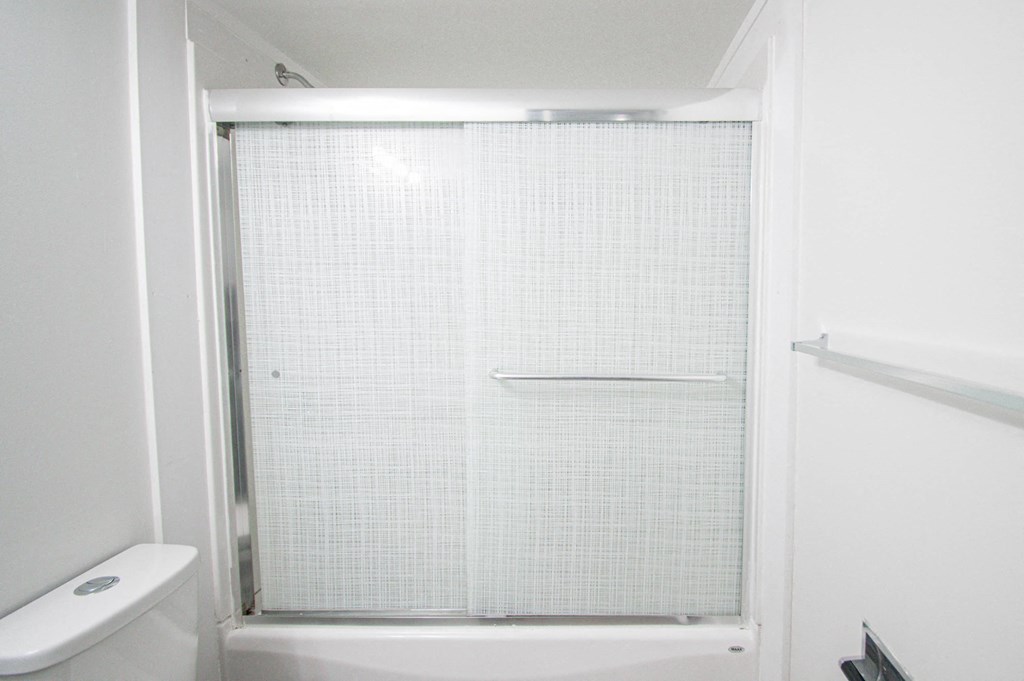 a small bathroom with a shower and a toilet