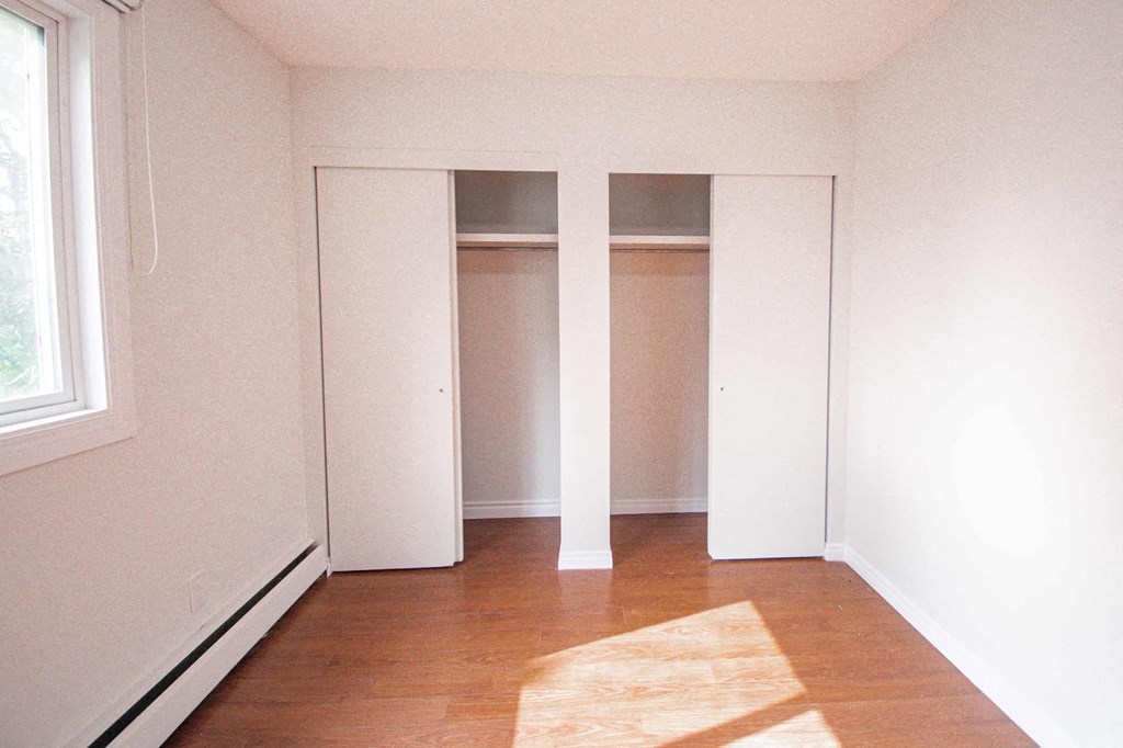 an empty room with three closet doors in it