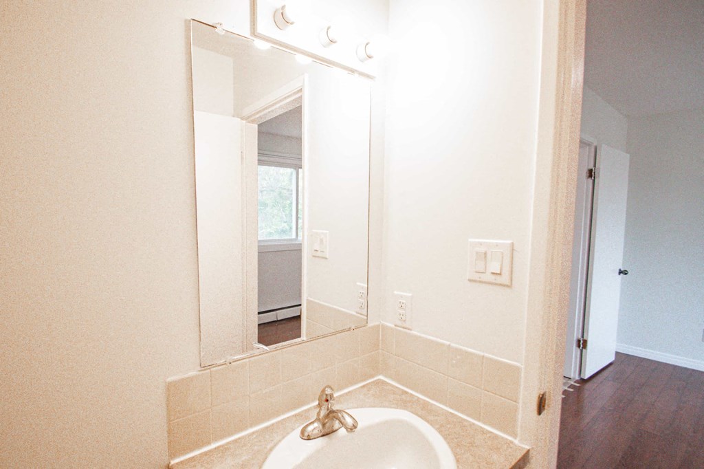 a small bathroom with a sink and a mirror