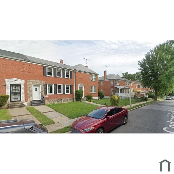 a red car parked on the side of a street