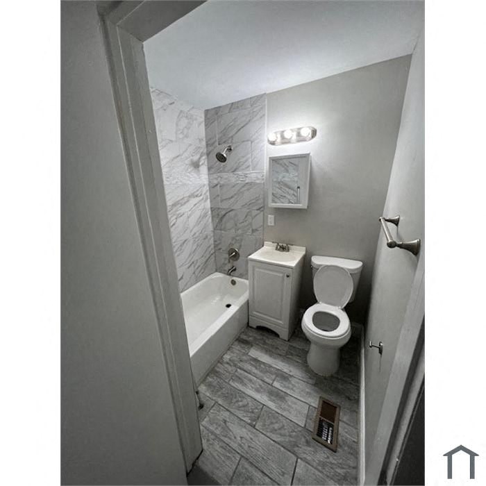a small bathroom with a toilet and a tub