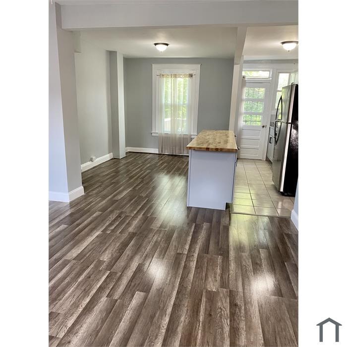 A kitchen with a wooden floor and white appliances.