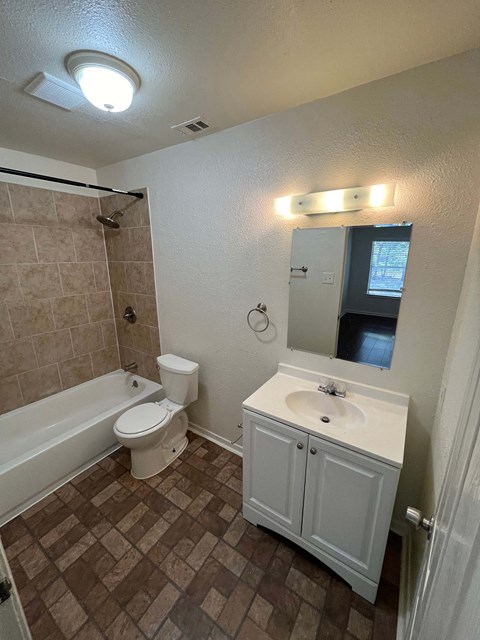 a bathroom with a sink toilet and a bath tub