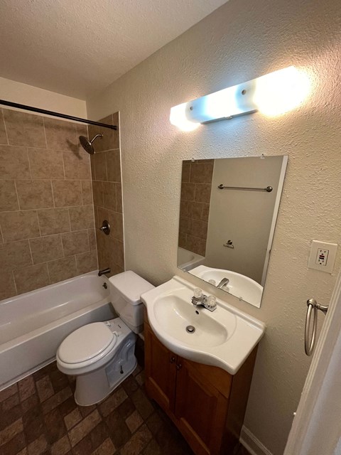 a bathroom with a sink toilet and a tub