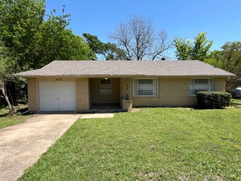 A house with a garage and a driveway.