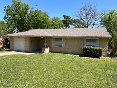 A house with a garage and a driveway.