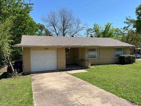 A house with a garage door numbered 55.