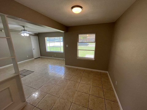 A room with tiled flooring and a ceiling fan.