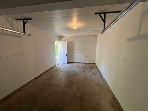 A long, empty hallway with a door at the end.