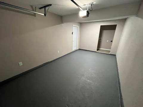 A spacious room with a door and a window.