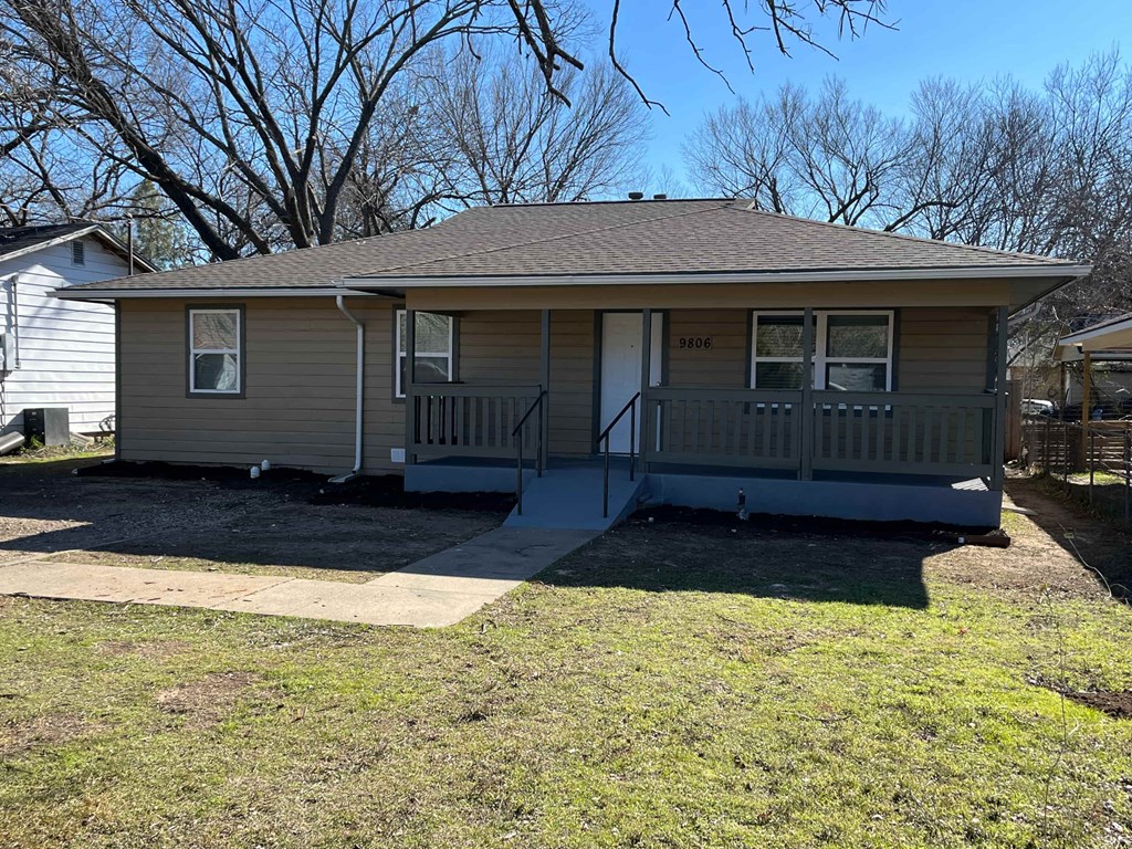 A house with a grey roof and a porch.