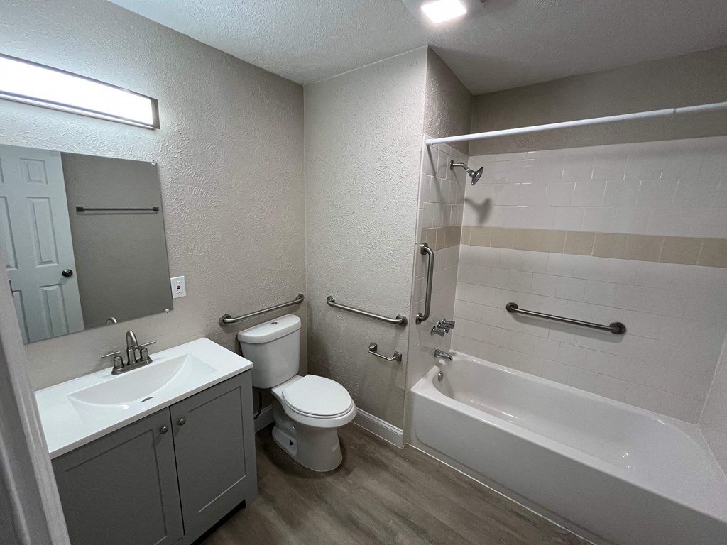 A bathroom with a toilet, sink, and bathtub.
