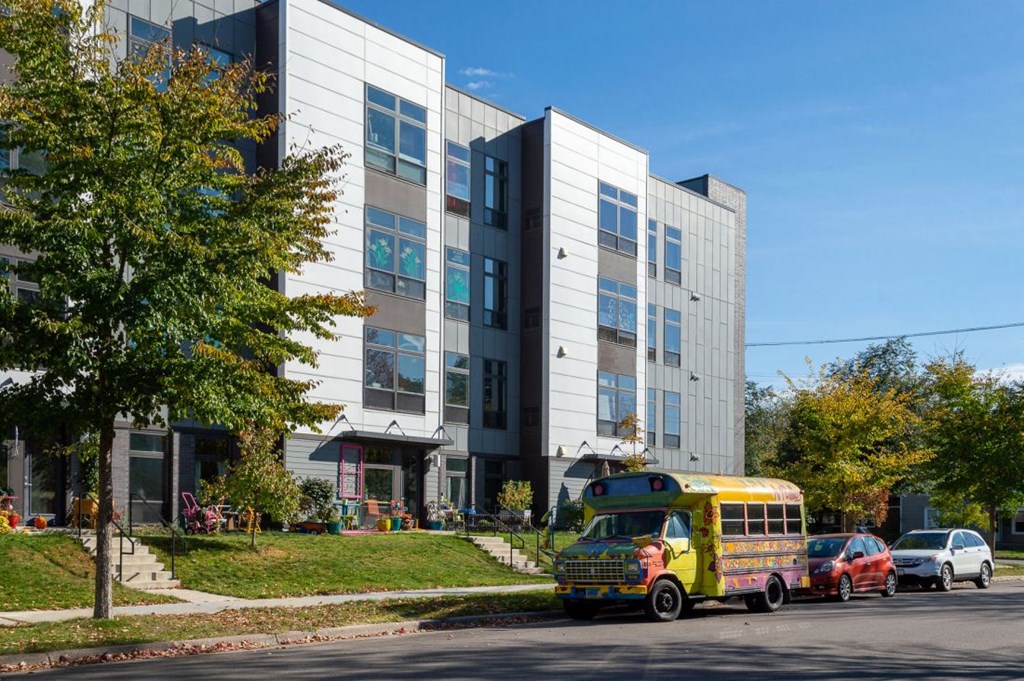 a yellow school bus parked in front of a building