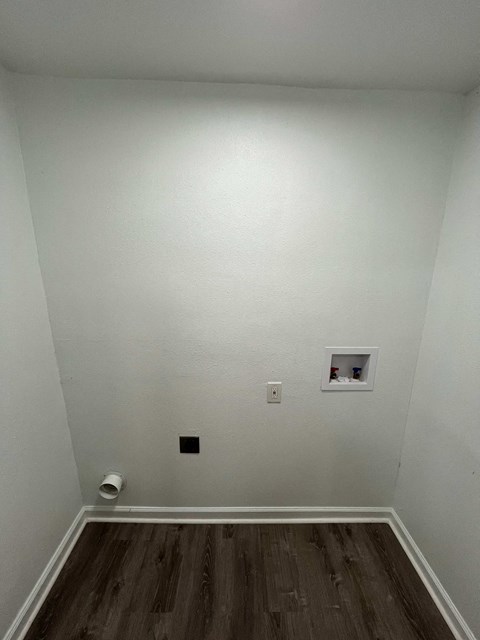 A white wall with a switch and a small shelf.