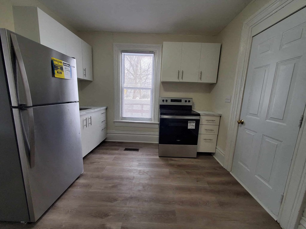 a kitchen with stainless steel appliances and white cabinets