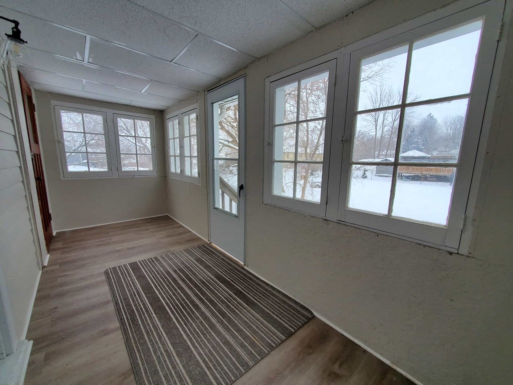 a living room with large windows and a rug