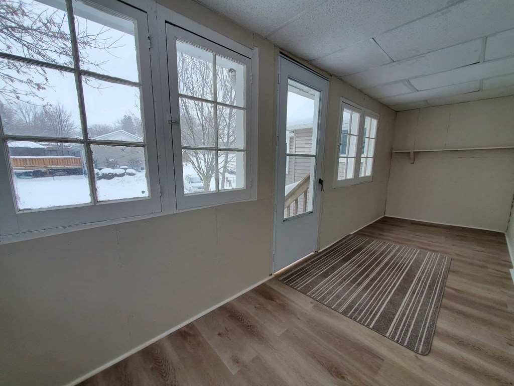 a living room with large windows and a rug