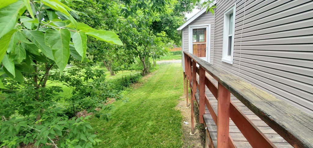 the side of a house with a path next to it