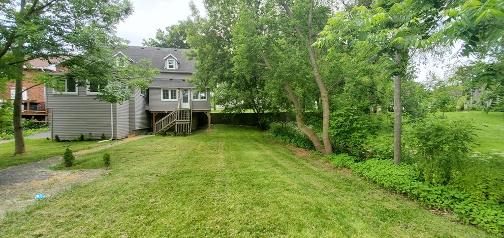 a large yard with a house in the background