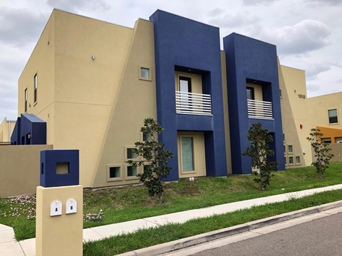 A modern building with blue and beige exterior.