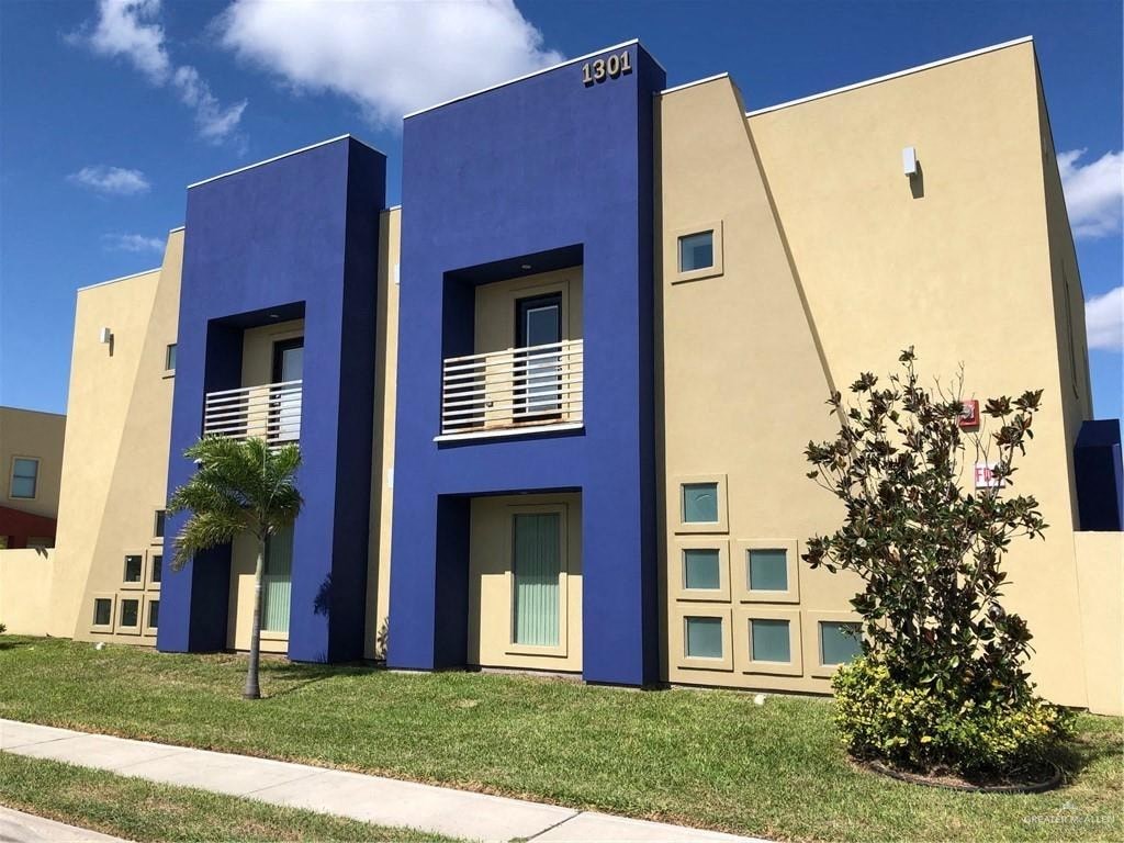 A blue and yellow building with the number 1301 on it.