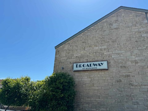A sign on a building that says "Broadway".