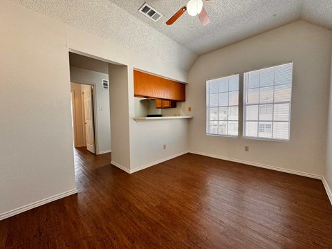 A room with wooden floors and a ceiling fan.
