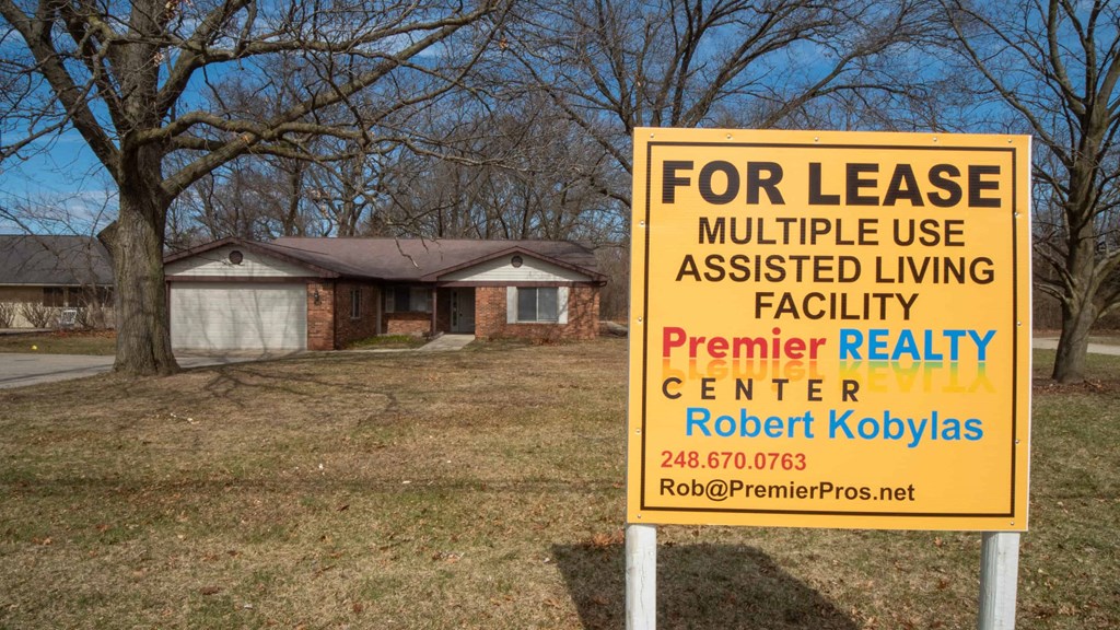 a sign is posted in front of a house
