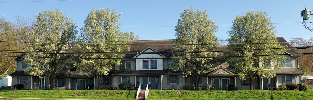 a large house with trees in front of it