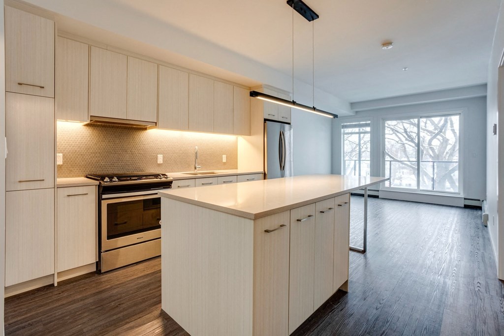 a large kitchen with white cabinets and a white counter top