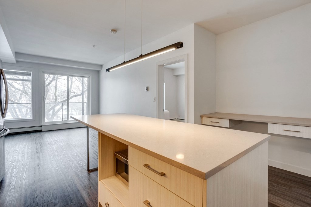 an empty kitchen with a large island in the middle