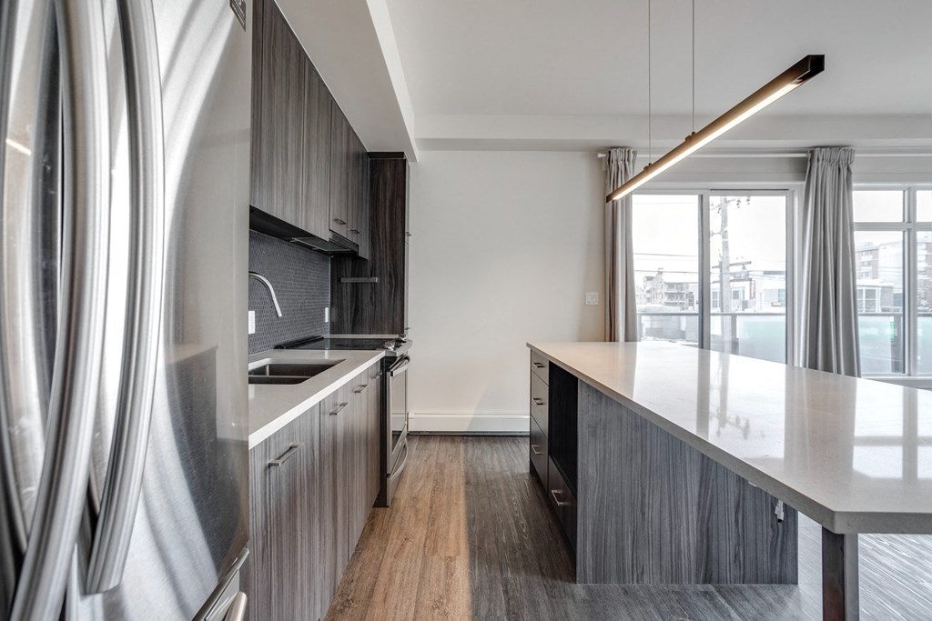 a kitchen with a large island and a large window