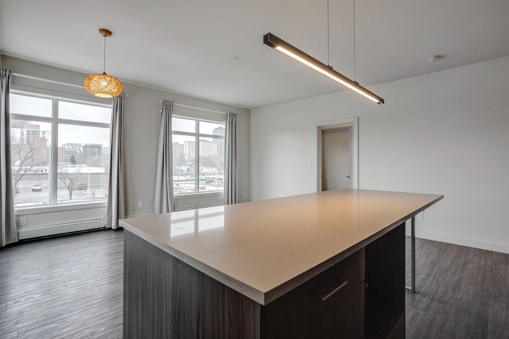 an empty kitchen with a counter top and a window