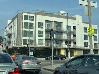 a busy city street with cars in front of a building