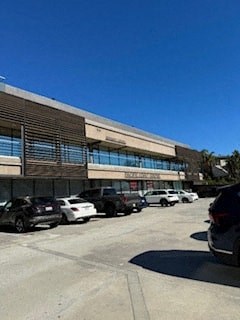 a building with cars parked in a parking lot