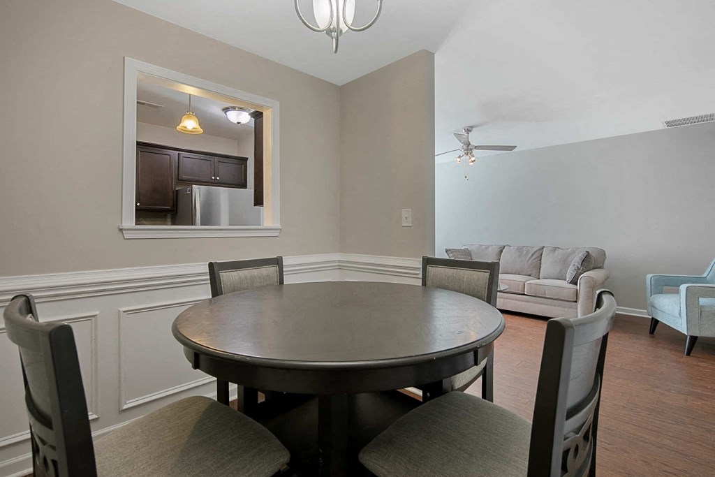 a dining room with a table and chairs and a living room
