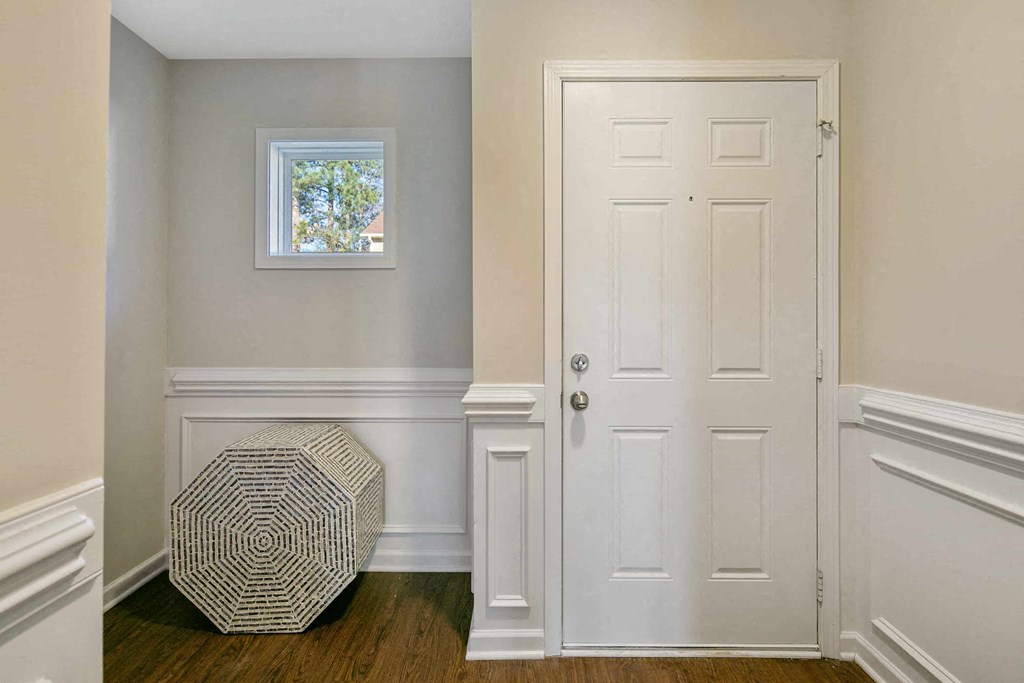 a room with white walls and a white door and a window