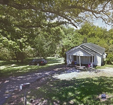A car is parked in front of a house.