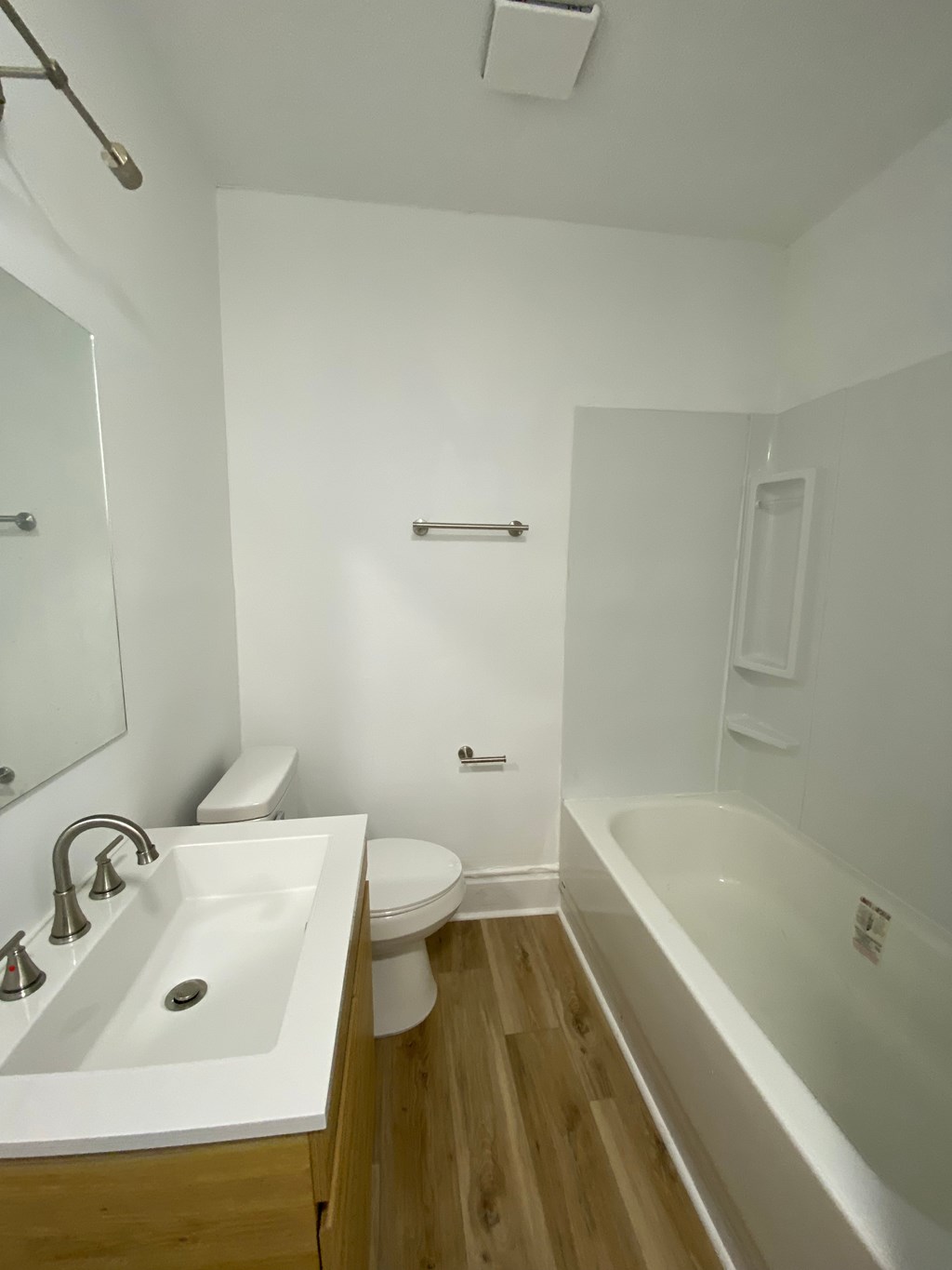 A white bathroom with a sink, toilet and bathtub.