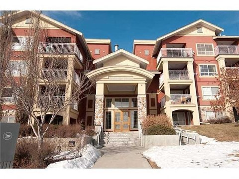 the front of an apartment building in the snow