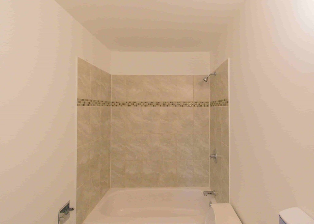 a small bathroom with a shower and a sink