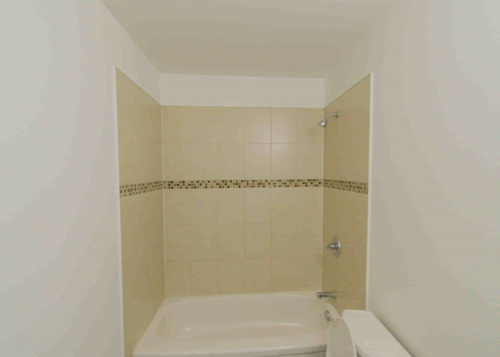 a small bathroom with a shower and a sink