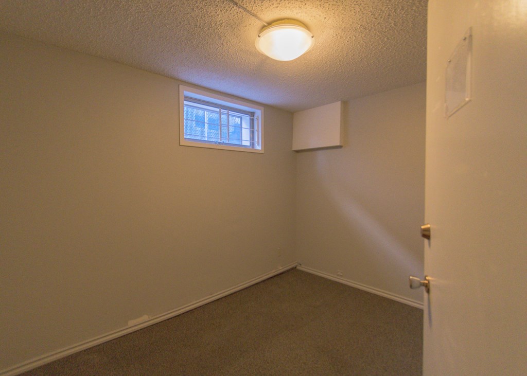 a small room with a window and a door