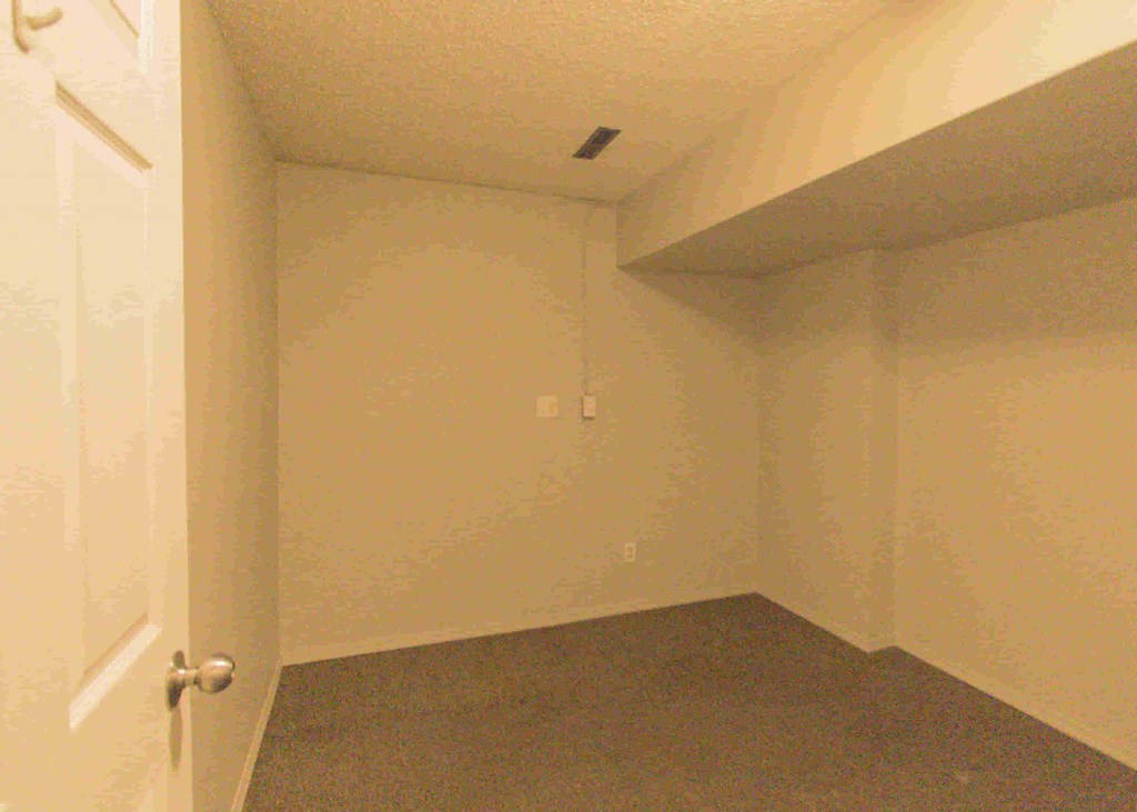 a room with a white wall and a door