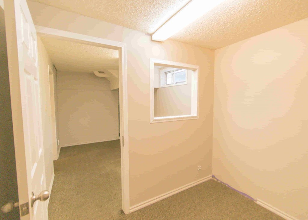 a bedroom with a closet and a door to a bathroom