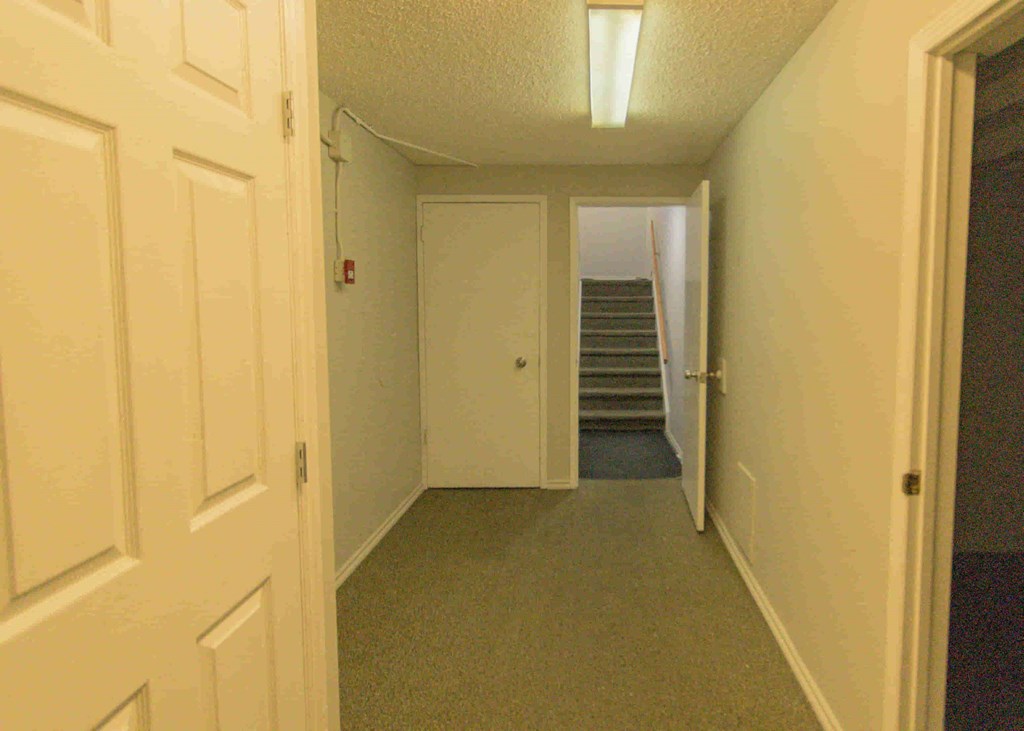 the hallway leading to the bedrooms and stairs to the loft