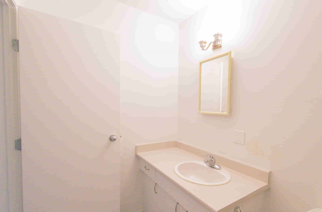 a small bathroom with a sink and a mirror