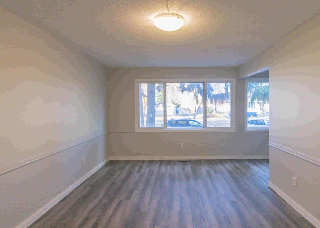 an empty room with white walls and a window